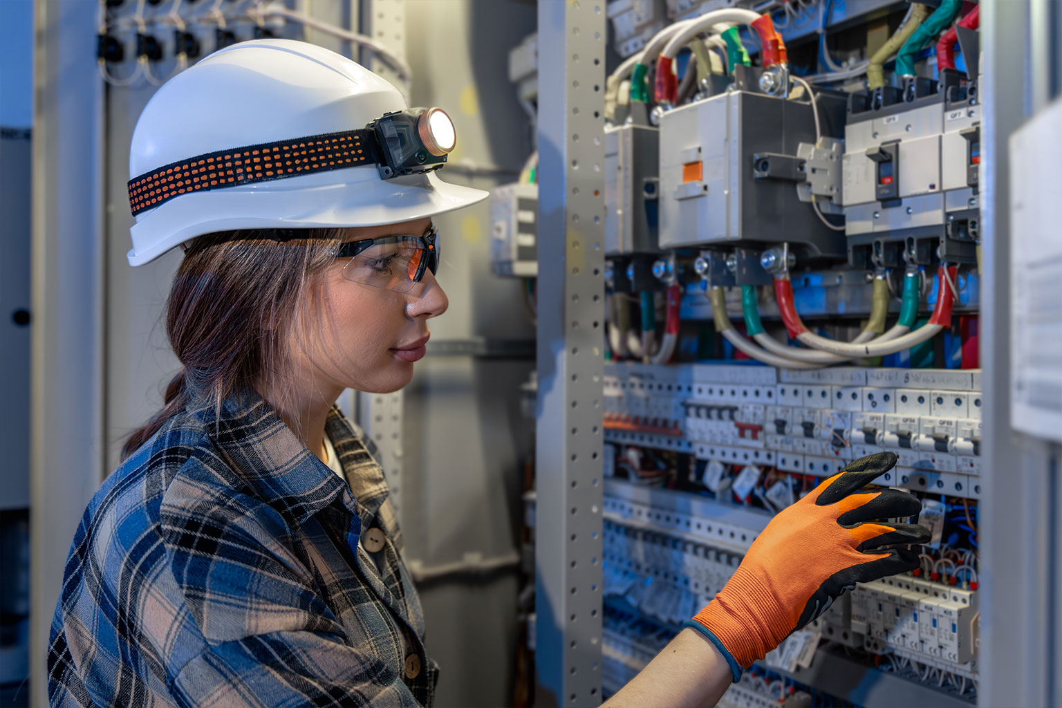 A maintenance worker inspects electrical equipment