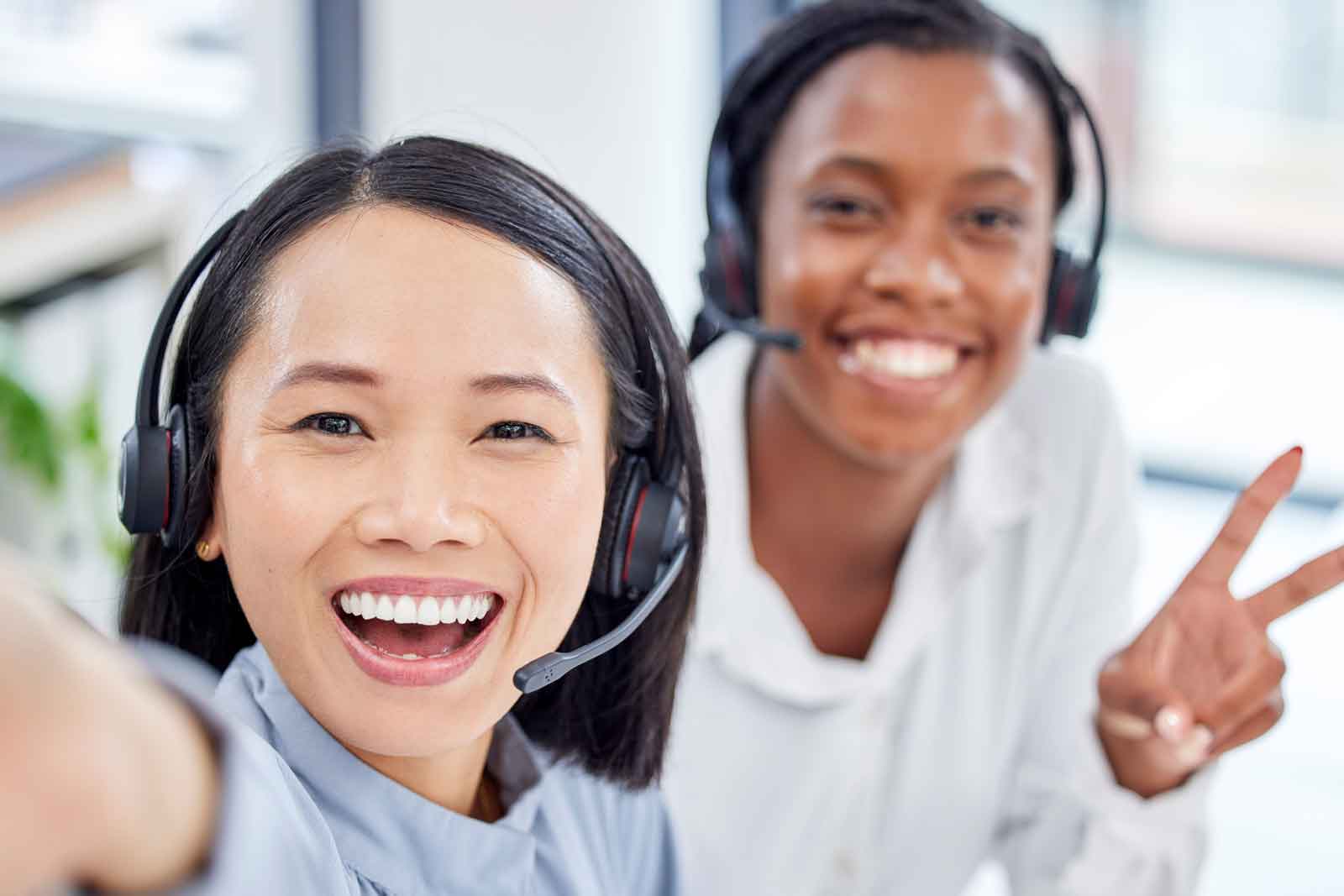 Service Contracts Two customer service employees pose happily for a selfie